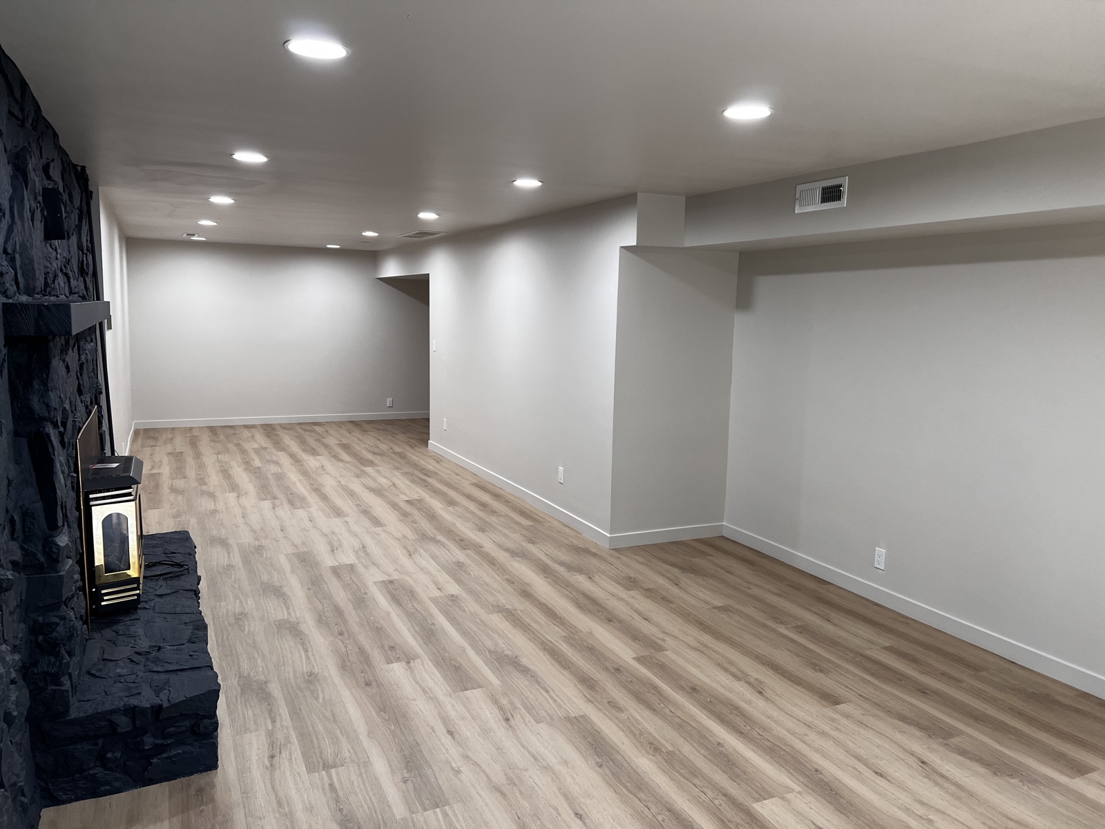 Residential interior painting — freshly painted living room with stone fireplace