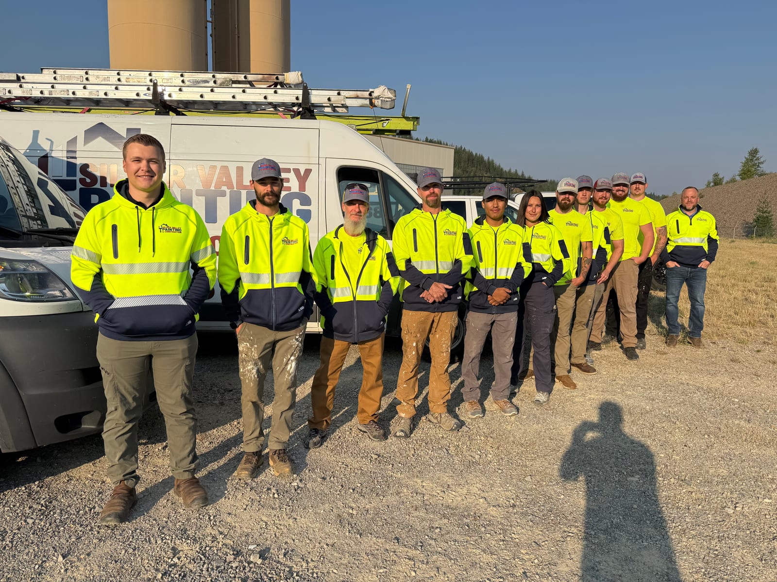 The Silver Valley Painting & Construction crew lined up in front of the company vans at a job site in North Idaho